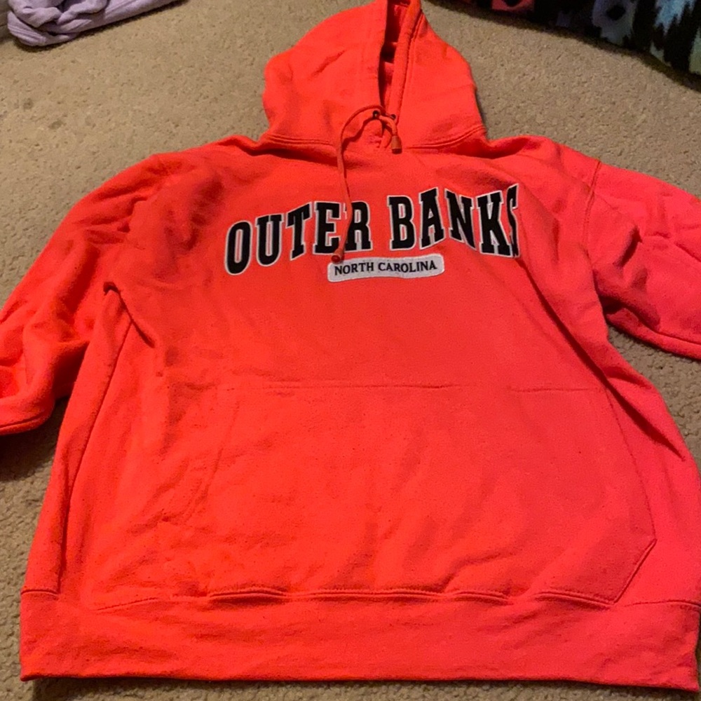 Heavily worn bright pink outer banks sweatshirt